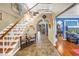 Inviting foyer with staircase, chandelier, and arched doorways to other rooms at 1449 45Th Ne Ave, St Petersburg, FL 33703