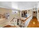 Second story hallway with hardwood floors, a sunlit window, and decorative wrought iron railing at 1449 45Th Ne Ave, St Petersburg, FL 33703