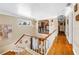 Upstairs hallway with hardwood floors and decorative wrought iron railing overlooking the foyer at 1449 45Th Ne Ave, St Petersburg, FL 33703