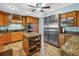 Spacious kitchen features custom wood cabinets, a large island, granite countertops, and stainless steel appliances at 1449 45Th Ne Ave, St Petersburg, FL 33703