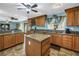 Bright eat-in kitchen with granite countertops, oak cabinetry, and large island at 1449 45Th Ne Ave, St Petersburg, FL 33703