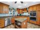 Kitchen boasts custom cabinets, granite countertops, stainless appliances, and a functional center island at 1449 45Th Ne Ave, St Petersburg, FL 33703