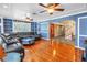 Bright living room featuring hardwood floors, a leather sectional, and custom shelving at 1449 45Th Ne Ave, St Petersburg, FL 33703