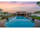 Backyard with an in-ground pool, landscaped yard, and covered patio with canal views at 1449 45Th Ne Ave, St Petersburg, FL 33703