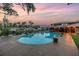 An inviting backyard pool boasts a canal view, complemented by patio space for relaxation and outdoor enjoyment at 1449 45Th Ne Ave, St Petersburg, FL 33703