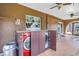 Enclosed lanai featuring built-in cabinets, washer and dryer, tile flooring, and multiple ceiling fans at 1449 45Th Ne Ave, St Petersburg, FL 33703