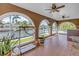 Enclosed lanai featuring large arched windows offering water views, tile flooring, and ceiling fans at 1449 45Th Ne Ave, St Petersburg, FL 33703
