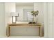 Clean entryway featuring a natural wood console table, decorative vase, and a modern mirror at 14970 Topaz Blue St, Wimauma, FL 33598
