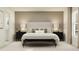 Serene main bedroom featuring a large bed with neutral linens, bedside tables, and contemporary lighting at 14970 Topaz Blue St, Wimauma, FL 33598