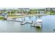 Community dock and boat lift on the water offering recreational opportunities and tranquil waterfront views at 1599 Running Tide Pl, Sarasota, FL 34240