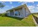 Backyard showing lawn, covered patio, and windows at 1599 Running Tide Pl, Sarasota, FL 34240