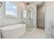 Bright bathroom with free-standing tub, glass shower, and walk-in closet at 1599 Running Tide Pl, Sarasota, FL 34240