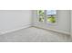 Bright bedroom featuring carpet flooring and multiple windows at 1599 Running Tide Pl, Sarasota, FL 34240