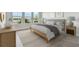 Sunlit bedroom featuring a neutral color scheme, plush bedding, and stylish furniture at 1599 Running Tide Pl, Sarasota, FL 34240