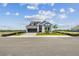 Lovely two-story home with blue accents, manicured lawn and professional landscaping at 1599 Running Tide Pl, Sarasota, FL 34240