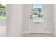 Bright foyer featuring a white door, neutral walls, and lovely natural light at 1599 Running Tide Pl, Sarasota, FL 34240