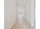 Clean, bright hallway with light wood floors, white walls, and recessed lighting at 1599 Running Tide Pl, Sarasota, FL 34240