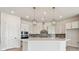 Bright kitchen with white cabinets, gray backsplash, and stainless steel appliances at 1599 Running Tide Pl, Sarasota, FL 34240