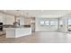 Open kitchen featuring white cabinets, gray backsplash, and modern light fixtures at 1599 Running Tide Pl, Sarasota, FL 34240