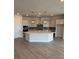 Open kitchen featuring a large island, modern appliances, and stylish pendant lighting at 1599 Running Tide Pl, Sarasota, FL 34240