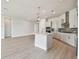 Bright kitchen with white cabinets, an island, and stainless steel appliances at 1599 Running Tide Pl, Sarasota, FL 34240