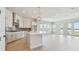 Open kitchen featuring white cabinets, gray backsplash, and modern light fixtures at 1599 Running Tide Pl, Sarasota, FL 34240