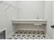 Simple laundry room with utility sink, quartz countertop and stylish floor at 1599 Running Tide Pl, Sarasota, FL 34240