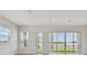 Bright living room with large windows and sliding glass doors offering serene water views at 1599 Running Tide Pl, Sarasota, FL 34240