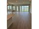 Bright living room with sliding glass doors offering stunning lake views and plenty of natural light at 1599 Running Tide Pl, Sarasota, FL 34240