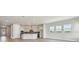 Open-concept kitchen and living area featuring modern appliances, lighting, and windows, perfect for entertaining guests at 1599 Running Tide Pl, Sarasota, FL 34240