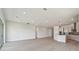 Spacious, open-concept living area with modern lighting and luxury vinyl plank flooring, ideal for entertaining at 1599 Running Tide Pl, Sarasota, FL 34240