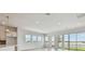Open living space with abundant natural light, recessed lights, and views of a lake and outdoor space at 1599 Running Tide Pl, Sarasota, FL 34240