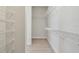 Spacious walk-in closet with wire shelving on all sides and light wood look flooring at 1599 Running Tide Pl, Sarasota, FL 34240