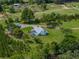 Aerial view of home on a large lot with a pool and screened enclosure at 16326 Kalli Way, Dade City, FL 33523