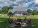 A fire pit is surrounded by chairs in the backyard of this beautiful property at 16326 Kalli Way, Dade City, FL 33523