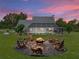Backyard firepit with screened in porch in a backyard with mature trees and a serene setting at 16326 Kalli Way, Dade City, FL 33523