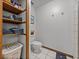 Cozy bathroom with a toilet, a built-in shelving unit and tile flooring at 16326 Kalli Way, Dade City, FL 33523