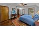 Bedroom with hardwood floors, ceiling fan, natural light, and a colorful rug at 16326 Kalli Way, Dade City, FL 33523
