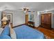 Bedroom with hardwood floors, ceiling fan, natural light, and a colorful rug at 16326 Kalli Way, Dade City, FL 33523
