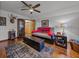 Bonus room featuring hardwood floors, a ceiling fan, and display cabinet at 16326 Kalli Way, Dade City, FL 33523