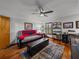 Bonus room with hardwood floors, a ceiling fan, and a leather ottoman at 16326 Kalli Way, Dade City, FL 33523