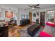 Bonus room featuring a desk, mounted television, hardwood floors and a ceiling fan at 16326 Kalli Way, Dade City, FL 33523