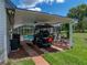 Carport next to pool area with golf cart and air conditioning units at 16326 Kalli Way, Dade City, FL 33523
