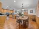 Dining room featuring hardwood floors, paneled walls, and a wooden table with seating for four at 16326 Kalli Way, Dade City, FL 33523