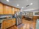 Kitchen/dining area featuring stainless steel appliances, hardwood floors, and a wooden table with chairs at 16326 Kalli Way, Dade City, FL 33523