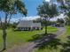 Charming home with a metal roof, expansive yard, and detached garage with plenty of parking at 16326 Kalli Way, Dade City, FL 33523
