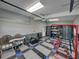 Well-lit garage featuring patterned flooring, overhead lighting, ample storage, and garage furnishings at 16326 Kalli Way, Dade City, FL 33523