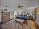 Comfortable main bedroom with a king bed, wood flooring, and a ceiling fan at 16326 Kalli Way, Dade City, FL 33523