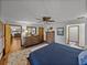 Spacious main bedroom with hardwood floors, decorative furniture and access to ensuite bathroom at 16326 Kalli Way, Dade City, FL 33523