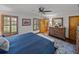 Spacious main bedroom with hardwood floors, shuttered windows, and decorative furniture at 16326 Kalli Way, Dade City, FL 33523